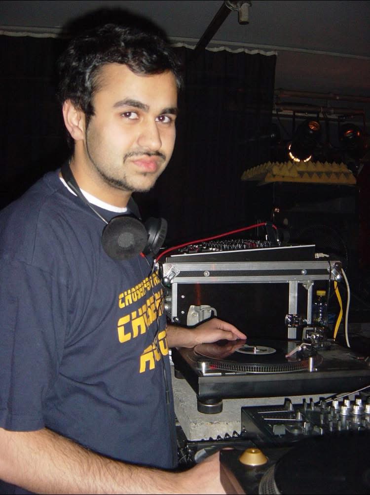 DJ Farhot behind the decks in a Chosen Few shirt